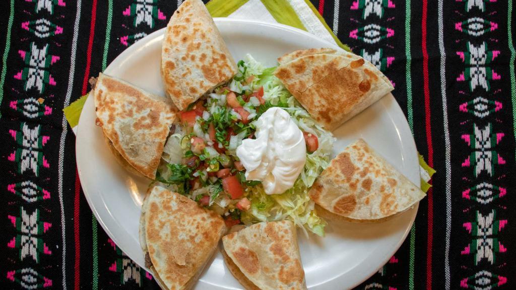 Veggie Quesadillas · 3 Quesadillas with melted mexican white cheese sandwiched between a flour tortilla. Served with lettuce, pico de gallo, and sour cream.