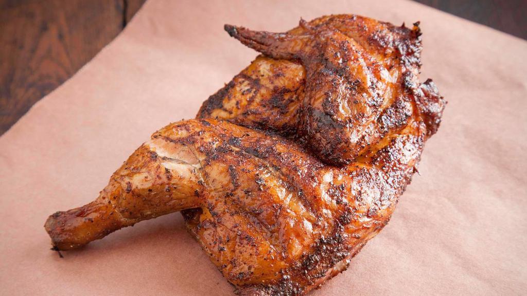 Half Chicken · Price is for each half chicken. All natural chicken breast, wing, leg, and thigh with a smoky flavor, golden color, and visible grill marks from the pit. Weighing about one and a quarter pounds per half.