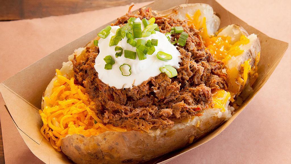 Chopped Brisket Baked Potato · A Texas sized baked potato loaded with chopped brisket, longhorn cheddar cheese, butter, sour cream and chives.