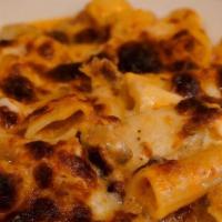 Pasta Bake · Rigatoni pasta, ground beef and Italian sausage baked in tomato cream sauce, topped with mel...