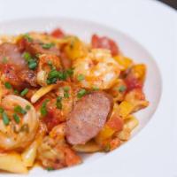 Cajun Pasta · Brown Gulf shrimp, crawfish tails, andouille sausage, and yellow peppers sauteed in a spicy ...