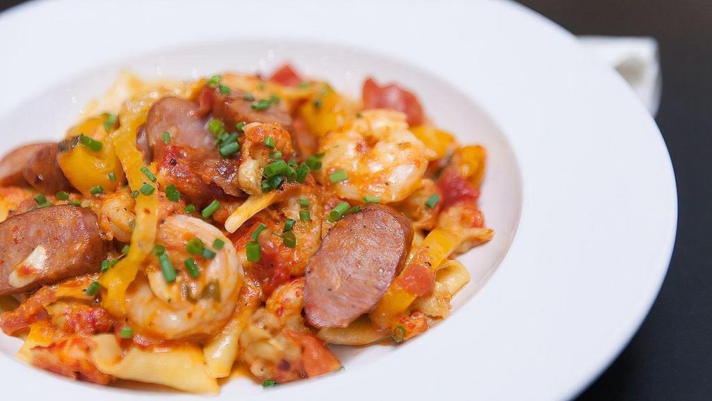 Cajun Pasta · Brown Gulf shrimp, crawfish tails, andouille sausage, and yellow peppers sauteed in a spicy arrabiata sauce with pappardelle pasta.
