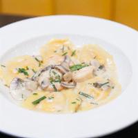 Lobster Ravioli · Lobster stuffed ravioli noodles with sauteed brown Gulf shrimp, mushrooms, and chives in a s...