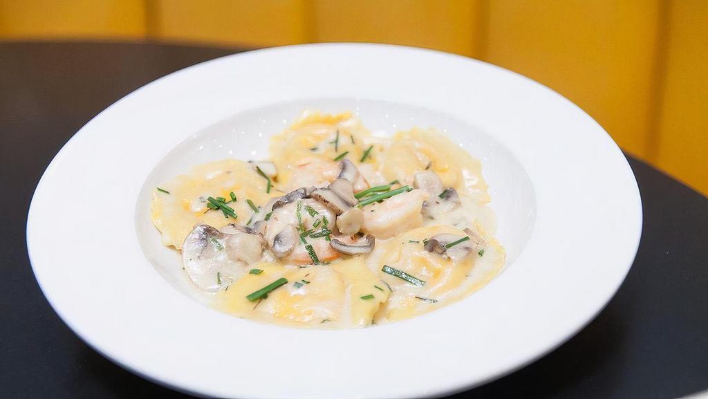Lobster Ravioli · Lobster stuffed ravioli noodles with sauteed brown Gulf shrimp, mushrooms, and chives in a sherry cream sauce.