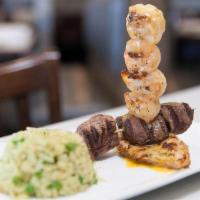Hasta Grill · 4oz grilled chicken breast served with beef tenderloin and grilled shrimp skewers topped wit...