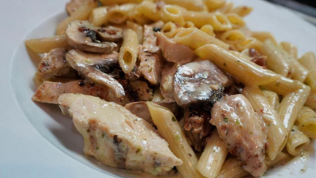 Verona W/Chicken · Mushrooms, chicken, and bacon with penne pasta tossed in a cilantro cream sauce.