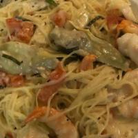 Picatta W/Shrimp · Sauteed shrimp topped with artichoke hearts, diced tomatoes, chives, and capers with angel h...