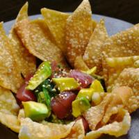 Ahi Poke With Chips · Sashimi grade ahi tuna marinated in poke sauce. Topped with diced avocado and served with cr...