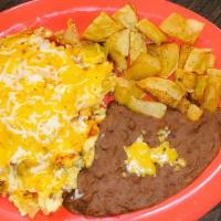 Migas · Tax two scrambled eggs with tortilla chips topped with ranchero sauce and melted cheese. Ser...