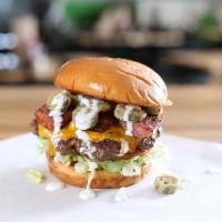 Jalapeño Sausage & Cheddar · Burger topped with jalapeño sausage, fried jalapeños, Cheddar lettuce, ranch dressing.
