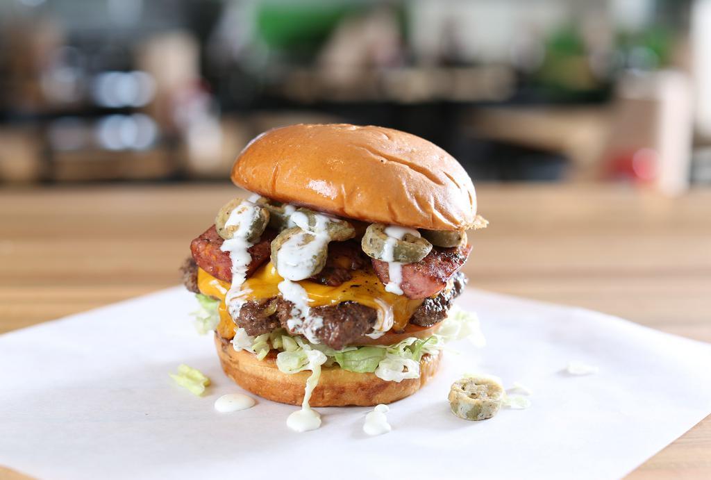 Jalapeño Sausage & Cheddar · Burger topped with jalapeño sausage, fried jalapeños, Cheddar lettuce, ranch dressing.
