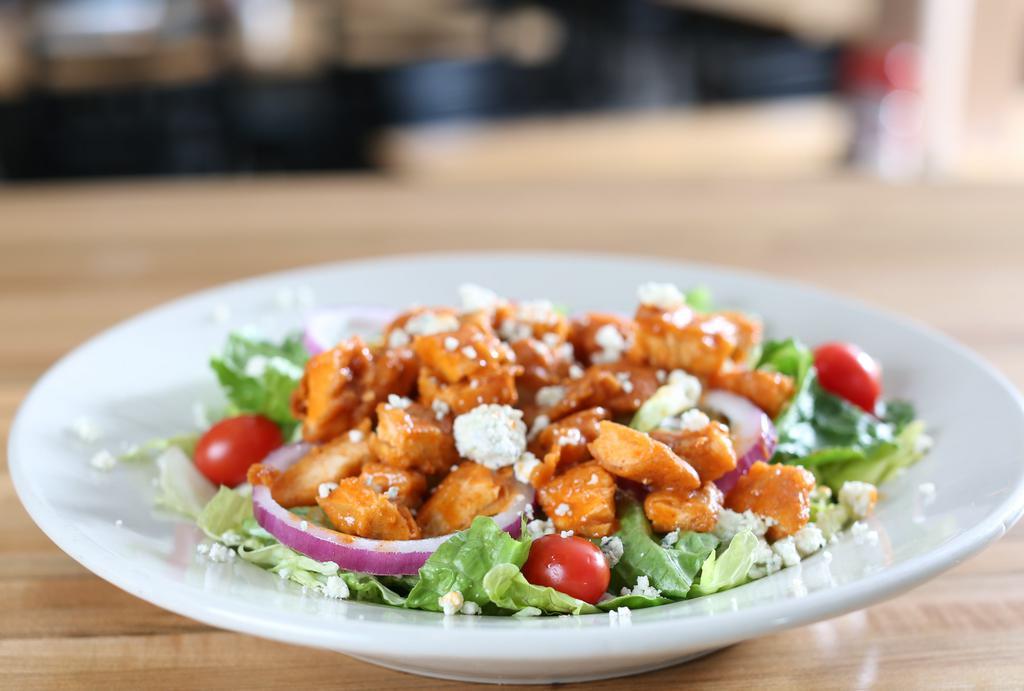 Bleu Buffalo Chicken · Buffalo chicken strips ( fried or grilled ) on romaine - red onion tomatoes - bleu cheese crumbles . served with ranch dressing .