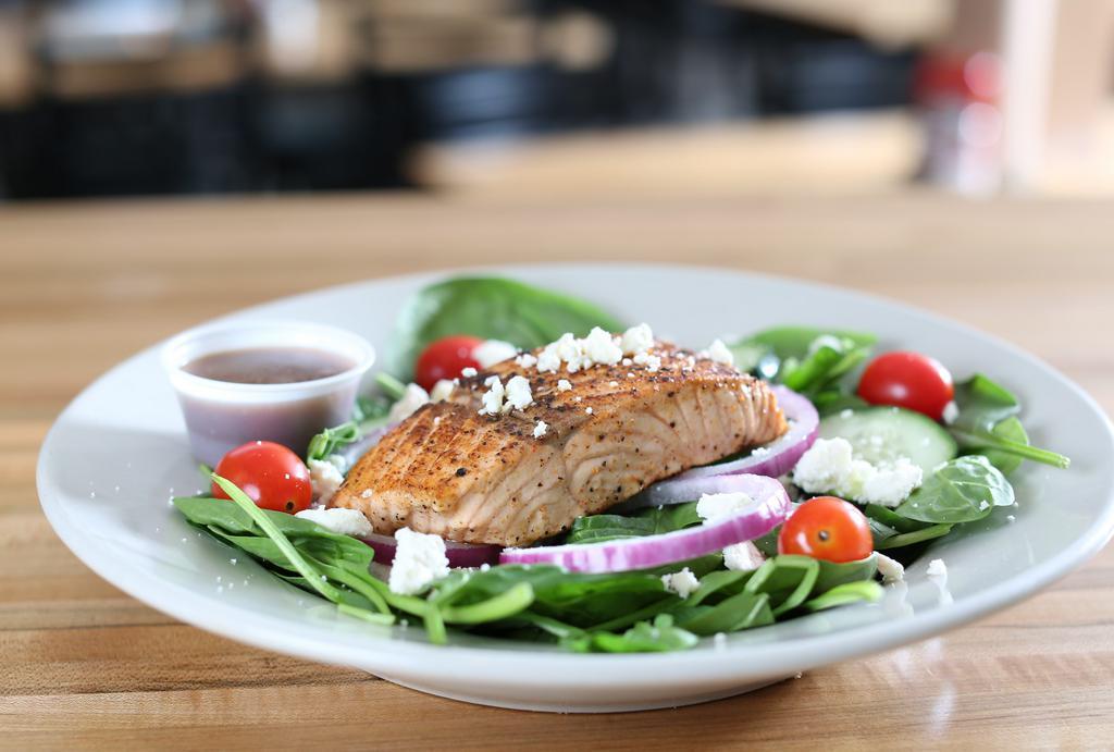 Spinach Salmon · Grilled atlantic salmon fillet on bed of fresh spinach - cherry tomatoes - red onion cucumbers - feta cheese . served with balsamic vinaigrette .