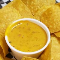 Tortilla Chips With Queso · Tortilla Chips with homeade queso (4 oz.)