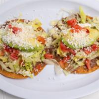 Tostadas · Fresh fried corn flat tortilla topped with choice of meat, refried beans lettuce, tomato, so...
