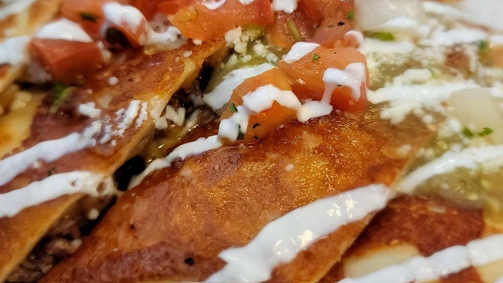 Quesadilla · Choice of grilled chicken or steak on a bed of lettuce topped with creamy salsa verde, sour cream, queso fresco and pico de gallo.