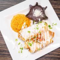 2 Piece Chimichangas · A deep-fried burrito stuffed with shredded chicken or shredded beef topped with queso dip an...