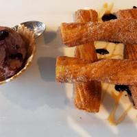 Churros · Fried pastry with black raspberry ice cream and finished with cinnamon sugar.