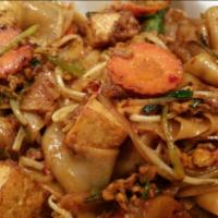 Curry Tofu Flat Noodles · Flat noodle stir fried with curry tofu and eggs, white onion, basil, mushroom, bell pepper, ...