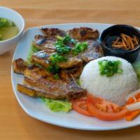 Grilled Lemongrass Pork Chops · Marinate grilled pork chops with lemongrass over steamed rice, topped with cucumber, tomatoe...