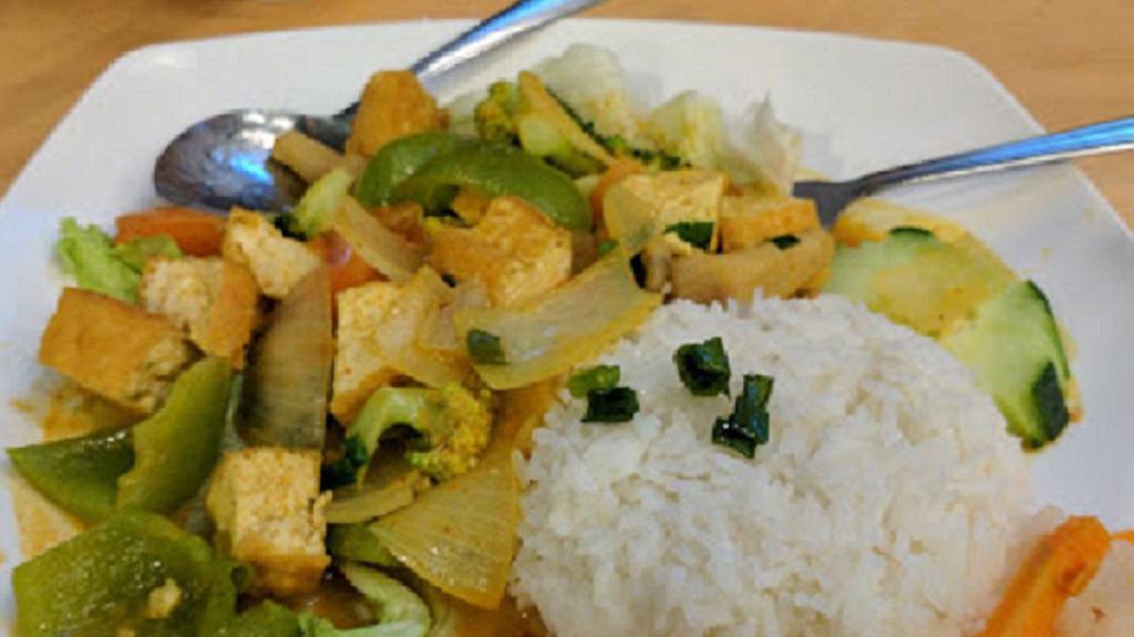 Curry Veggies & Tofu · Stir fried tofu and vegetables in mildly spicy yellow curry sauce served with steamed rice.