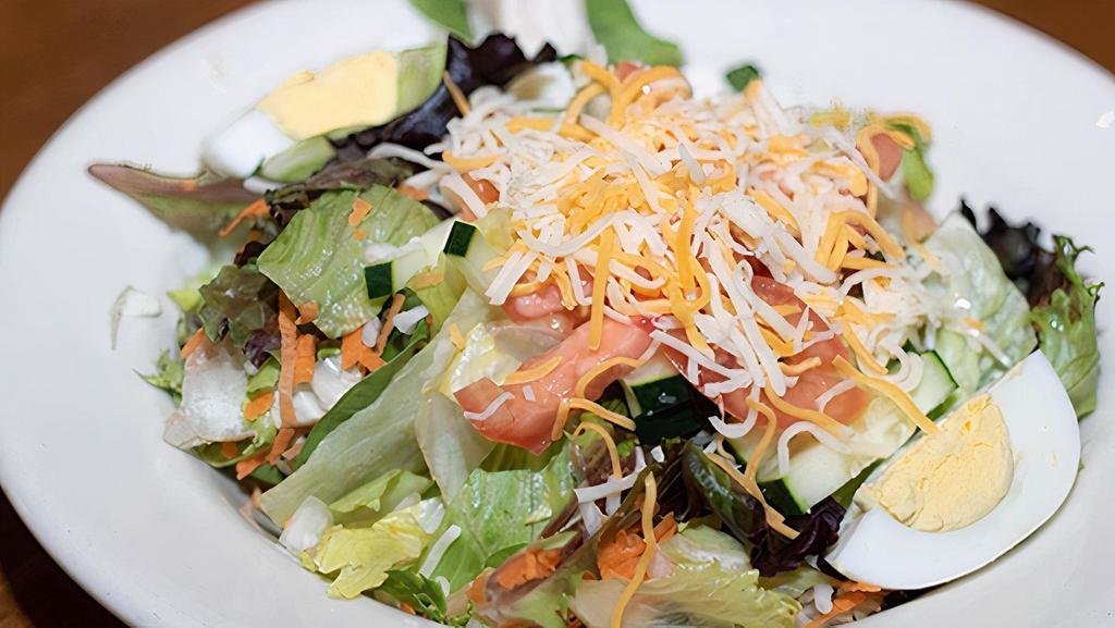 Traditional Salad · Mixed greens, tomatoes, cucumbers, cheddar-jack cheese, and hard boiled egg. Served with our homemade buttermilk ranch dressing.