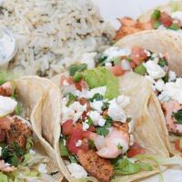 Atlantic Salmon Tacos · Four tacos filled with blackened Atlantic salmon, shredded lettuce, cilantro lime aioli, fet...