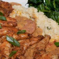 Shrimp And Grits · Large blackened shrimp on a bed of jalapeño cheese grits with smoked Andouille sausage gravy...
