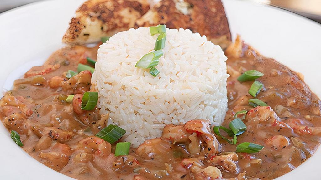 Crawfish Etouffee · Homemade, spicy, Louisiana style étouffée full of crawfish tails, served with white rice and toasted garlic bread.