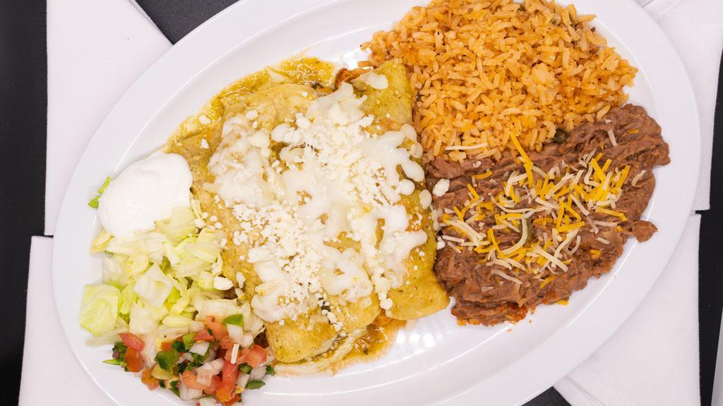 Enchiladas Verdes · Three chicken enchiladas covered in our homemade tomatillo green salsa, topped with queso fresco and sour cream served with rice, refried beans,