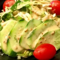 House Salad · Shredded cabbage, cherry tomato and cucumber with sesame dressing.