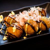 Takoyaki (7) · Diced octopus in a deep-fried bettered ball.