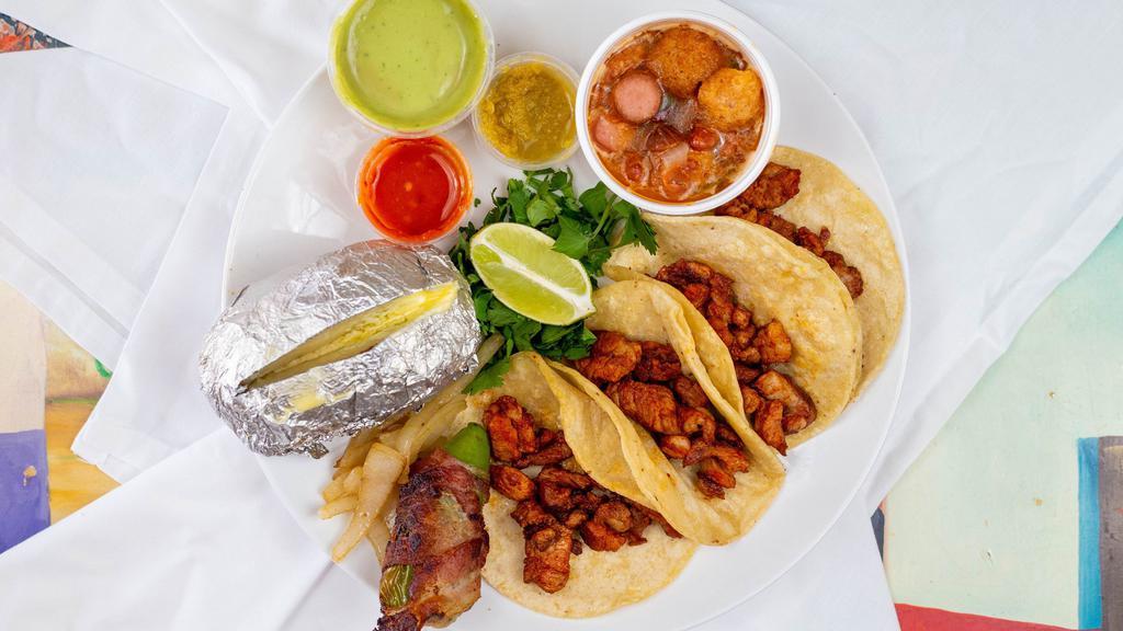 Tacos Al Pastor · Taco includes an order of 4 tacos, green onions, a jalapeño stuffed with cheese and wrapped in bacon, guacamole, roja, verde, and pico de gallo.