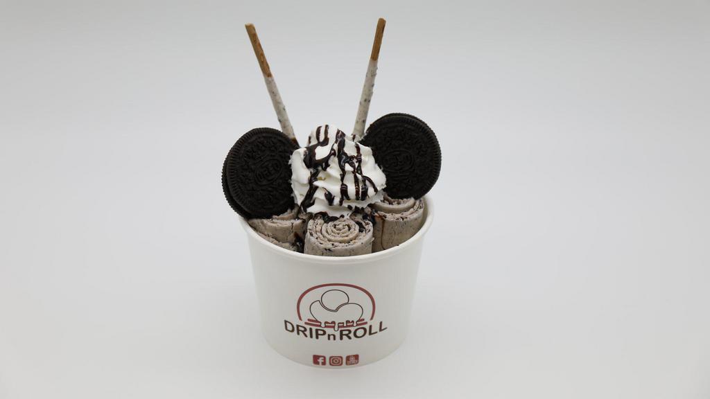 Cookie N' Cream · Vanilla ice cream mix in with oreos, topped with whipped cream, Oreos, cookies and cream pocky stickys and chocolate drizzle.