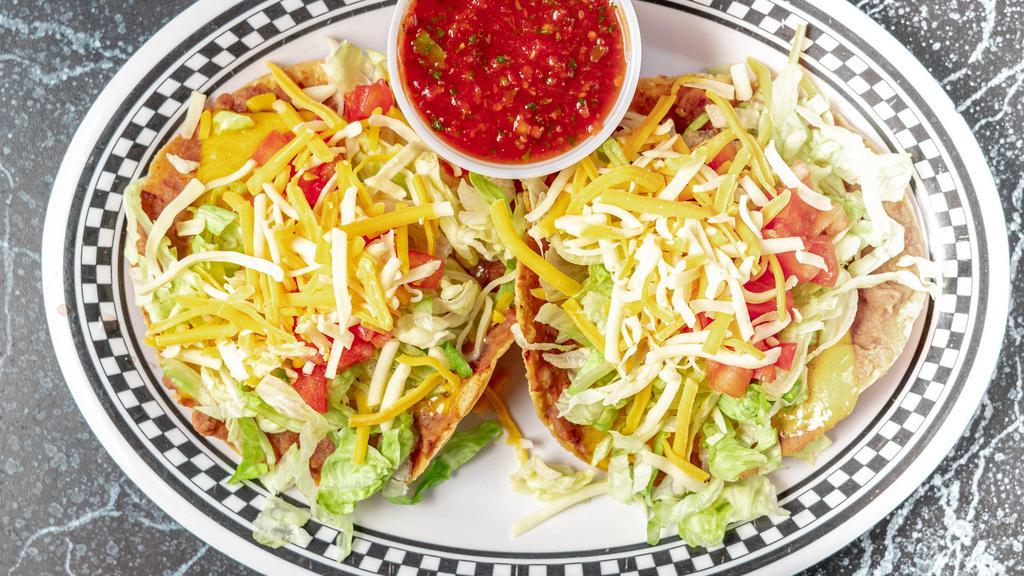 Chalupas · Crispy tortilla shells covered with vegetarian refried beans, mixed cheese, lettuce, tomato and a side of salsa. Add guacamole, sour cream for an additional charge.