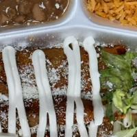 Enchiladas Plate · 3 Enchiladas cooked in red salsa With A Side of Rice & Beans and Salad Topped Off with Sour ...