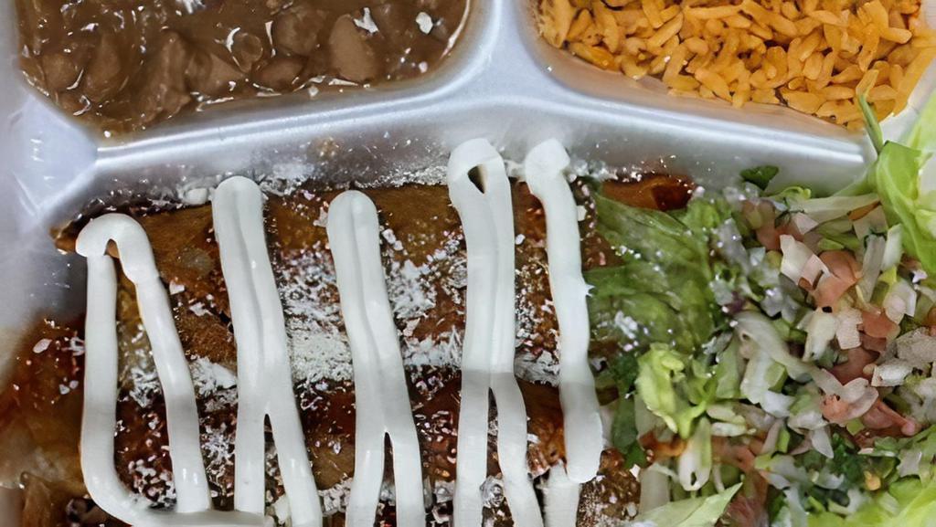 Enchiladas Plate · 3 Enchiladas cooked in red salsa With A Side of Rice & Beans and Salad Topped Off with Sour Cream