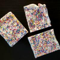 The Sprinkles · A bar with layers of shortbread, scrumptious white chocolate fudge, and white chocolate dott...