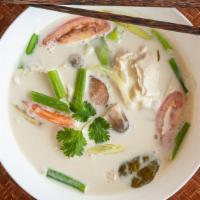 Tom Kha · Authentic coconut soup with tomato, onion, mushroom, lemongrass, kaffir leaves, galangal spi...