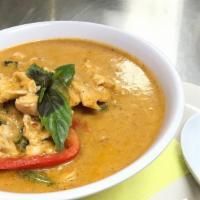 Panang Curry · Lime leaves , basil and bell peppers in Paneng Curry paste and coconut milk.