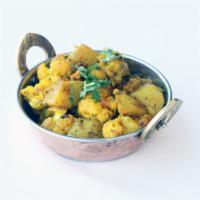 Aloo Gobi · Cauliflower & potatoes cooked with tomato, onion, herbs & spices garnished with fresh corian...