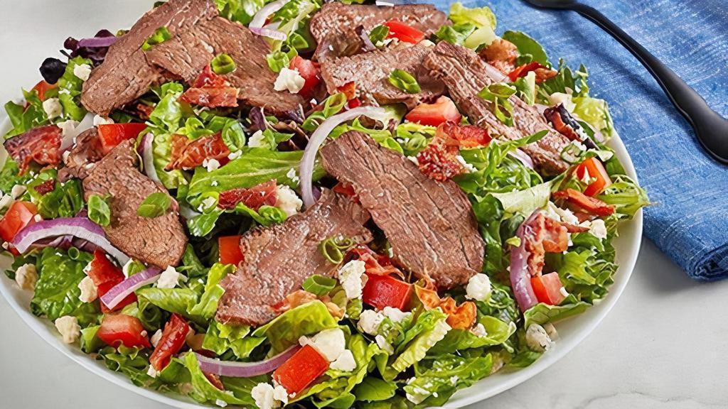 Steak And Gorgonzola Salad · Seared sirloin steak, gorgonzola cheese, applewood smoked bacon, tomato, red and green onion on a bed of mixed greens. Try it with Buttermilk Ranch dressing