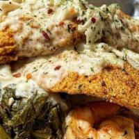 Cajun Seafood Stack · Dirty Rice or White Rice & Collard Greens, topped with Cajun Fried Catfish, Sauteed Shrimp &...