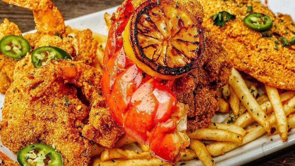 Cajun Fried Seafood Platter · Fried catfish filet, 6 fried shrimp and fried lobster tail served with fries.