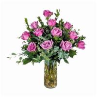 Dozen Lavender Roses · One dozen standard lavender roses beautifully arranged in a clear cylinder vase with mixed g...