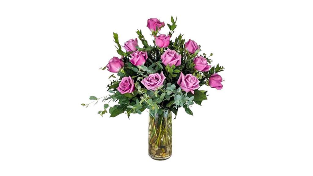 Dozen Lavender Roses · One dozen standard lavender roses beautifully arranged in a clear cylinder vase with mixed greenery, accented with river rocks.

Approx. 18