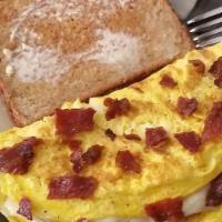 Bacon Omelet · Omelet with bacon and topped with cheese.