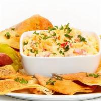Spicy Pimento Cheese · Grated sharp Cheddar, mayonnaise, diced red peppers, and Tabasco. Served with soft or baked ...