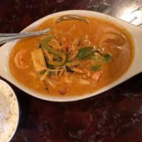 Red Curry · Spicy and savory red curry with bamboo shoots, carrots, green beans, and bell peppers with b...