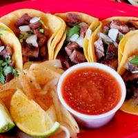 Carne Asada Street Tacos · 5 flamed grilled carne asada tacos made with small yellow corn tortillas. Served with diced ...